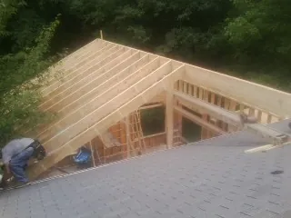 Framing a new roof addition that ties into an existing shingle roof in Albion